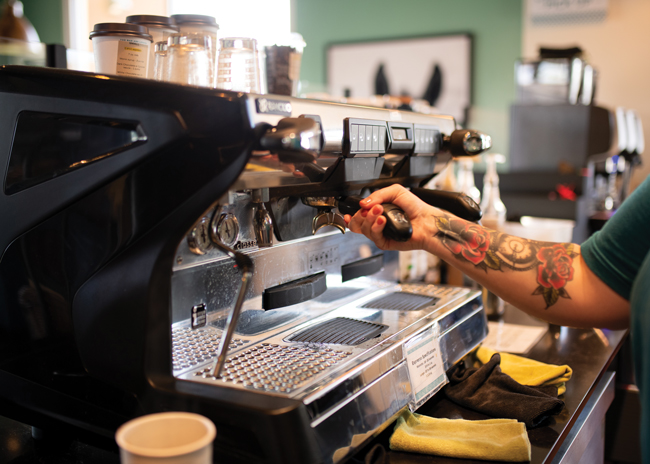 A traditional espresso machine, with its gauges, handles, and overall sleek industrial look, adds visual appeal to a coffee bar. Image courtesy of Bad Ass Coffee of Hawaii