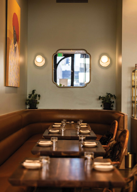 Joyce’s seating plan includes custom curved booths with textured fabric backs along the window and a double-sided banquette in the center of the dining room that provides flexibility to accommodate various party sizes. 