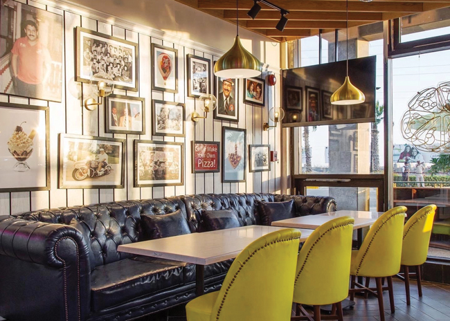 Happy Joe’s offers franchisees the choice of three tiers of furniture. The top tier, pictured here, includes leather couches and high-end upholstered chairs. Image courtesy of Tom Sacco