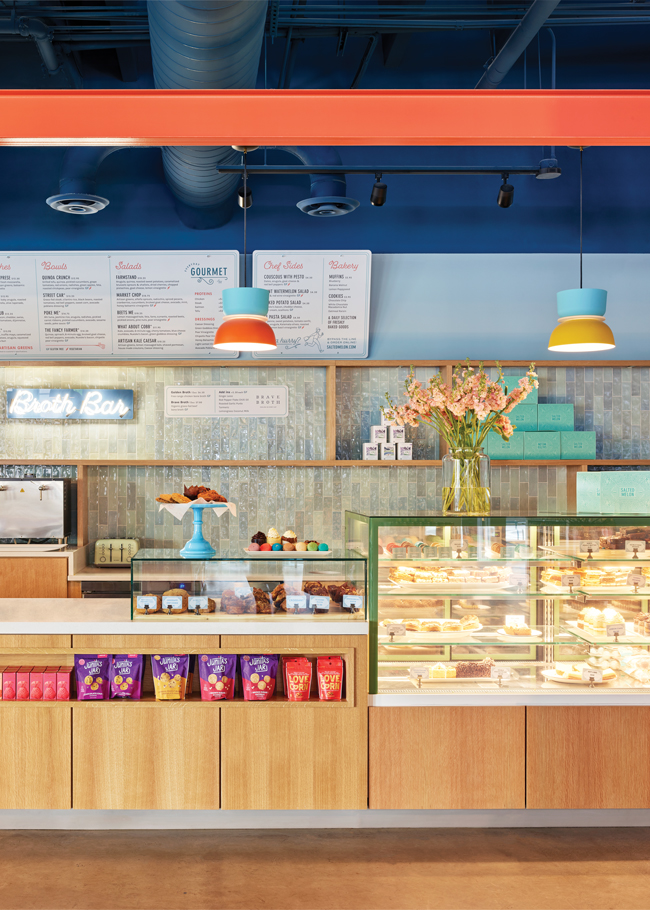 Beyond the market, guests approach a counter where fresh baked goods are displayed and orders can be placed from the all-day menu of coffees and teas, breakfast items, salads, sandwiches, wraps and signature bone broth. Image courtesy of Chris Edwards