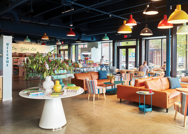 Colorful light fixtures hung at varying heights above the front lounge area helps to create a playful vibe. Image courtesy of Chris Edwards