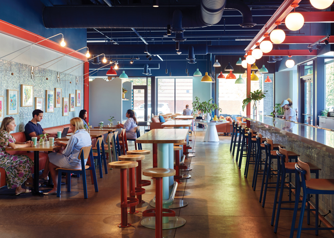 The main brand colors of light blue, dark blue and orange are bright, but  also comfortable and warm against natural-wood furnishings and stained concrete flooring.