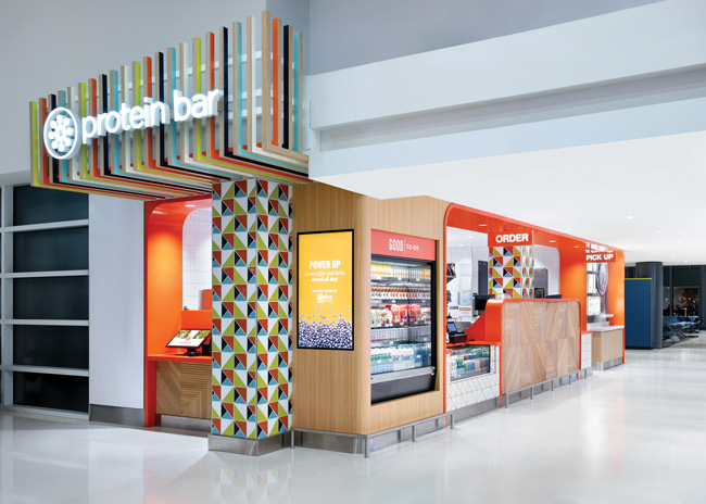 Protein Bar & Kitchen’s bold colors make it stand out in an airport setting. Image courtesy of Daniel Kelleghan Photography