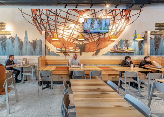The large graphic wallcovering at Smashburger in Queens, N.Y., designed by MG2, Seattle, is a bold branding statement but less expensive than an artist’s mural. Image courtesy of Andrew Werner