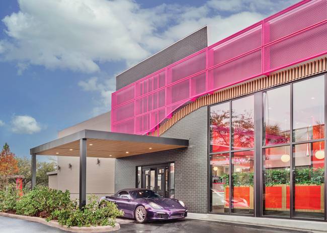 The design utilizes a door instead of a window at the drive-thru. This shows the chain’s operations  have nothing to hide, while helping  build connection between guests and team members.