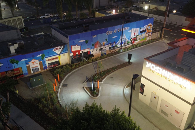 Compton-born artist Mel Depaz created a large-scale exterior mural that transforms a shared wall into a celebration of local culture.