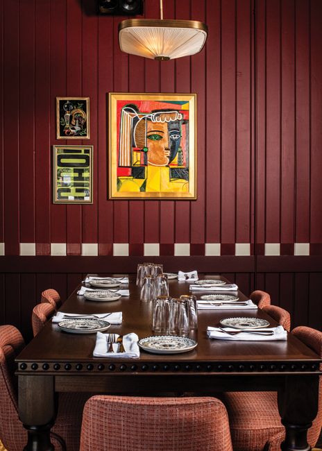 The custom-crafted Nonna’s Table sits beneath a painting by local artist Natalie Osborne, who specializes in striking, colorful portraits of women. Images courtesy of Dimmi Dimmi Corner Italian