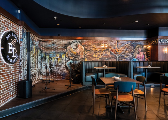 The small stage at the Nashville Bar Louie is backed by a hand-painted mural. Images courtesy of Bar Louie