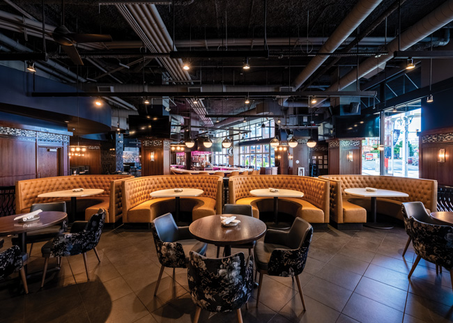 Seating options in the dining room include horseshoe booths and upholstered armchairs.