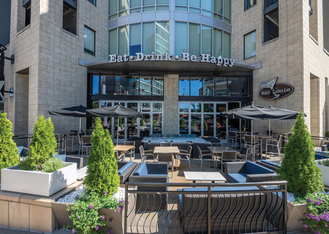 Soft seating and an 18-inch-deep ledge around the firepit allow guests to enjoy a meal outdoors.